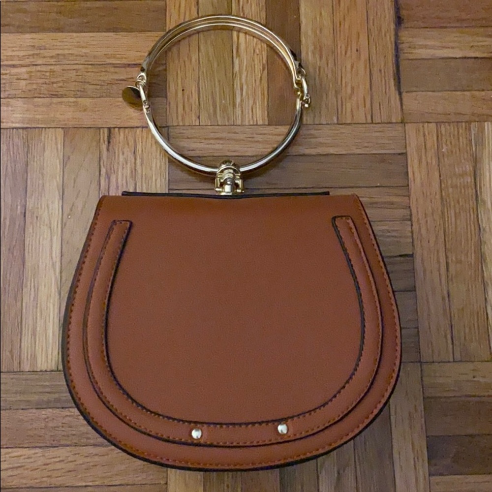 Never used brown bag with gold circular handle